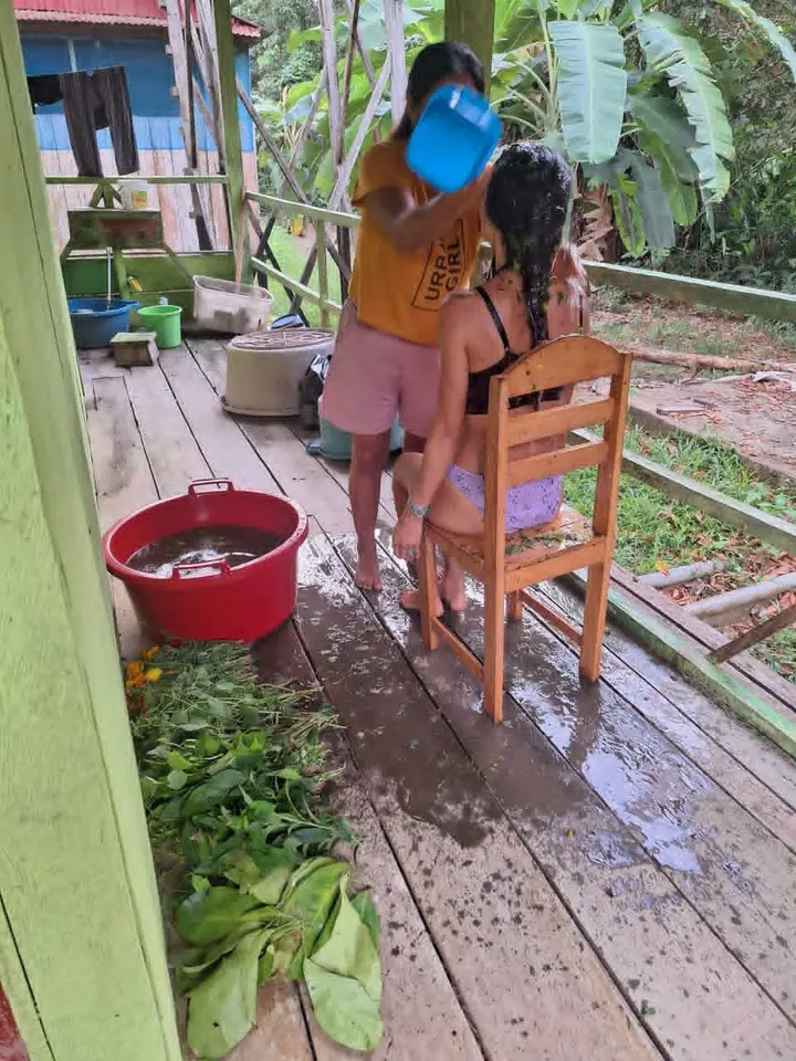 An outdoor herbal cleansing ritual at a rainforest lodge.